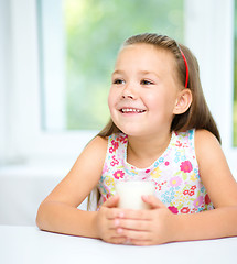 Image showing Cute little girl with a glass of milk