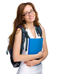 Image showing Young student girl is holding book