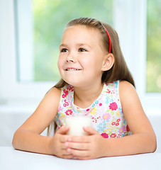 Image showing Cute little girl with a glass of milk