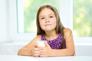 Image showing Cute little girl with a glass of milk