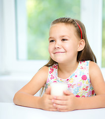 Image showing Cute little girl with a glass of milk