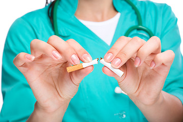 Image showing Doctor in uniform breaks cigarette