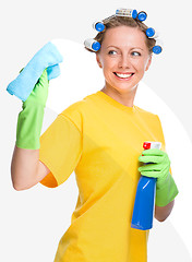 Image showing Young woman is cleaning glass using rag