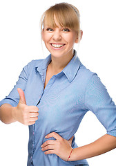 Image showing Woman is showing thumb up gesture