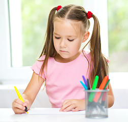 Image showing Cute cheerful child drawing using felt-tip pen