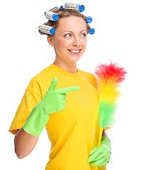 Image showing Young woman with curlers and static duster