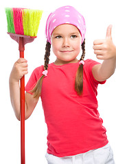 Image showing Young girl is dressed as a cleaning maid