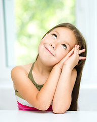 Image showing Little girl is daydreaming