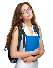 Image showing Young student girl is holding book