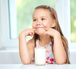 Image showing Cute little girl with a glass of milk