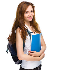 Image showing Young student girl is holding book