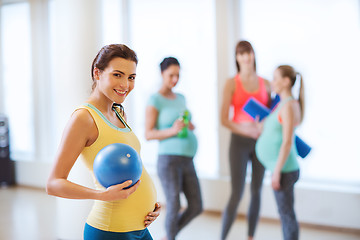 Image showing happy pregnant woman with ball in gym