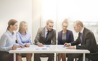 Image showing business team with documents having discussion