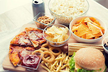 Image showing close up of fast food snacks and drink on table