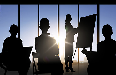 Image showing business people silhouettes at meeting in office