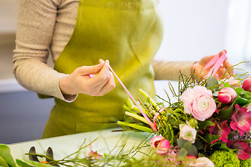 Image showing close up of woman making bunch at flower shop