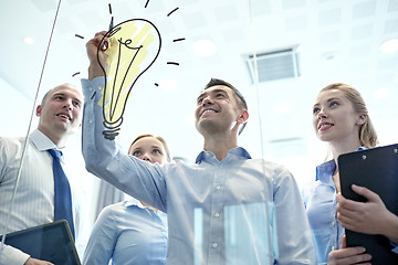 Image showing smiling business people with marker and stickers