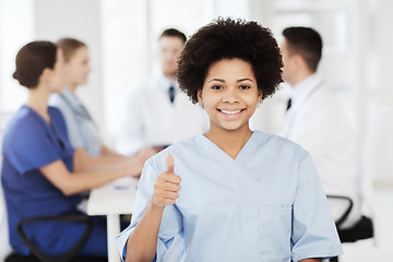 Image showing happy doctor over group of medics at hospital