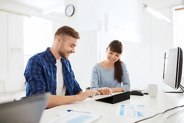 Image showing creative team with tablet pc and papers at office