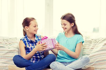 Image showing happy little girls with birthday present at home