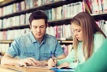 Image showing students writing to notebooks in library