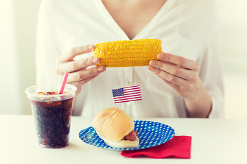 Image showing woman hands holding corn with hot dog and cola