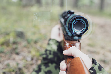 Image showing close up of soldier or sniper with gun in forest