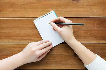 Image showing close up of woman or student writing to notepad