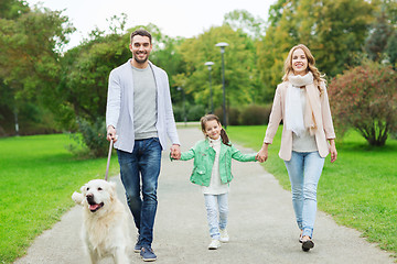 Image showing happy family with labrador retriever dog in park