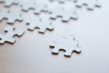 Image showing close up of puzzle pieces on wooden surface