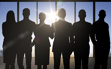 Image showing business people silhouettes over office background