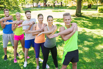 Image showing group of friends or sportsmen exercising outdoors