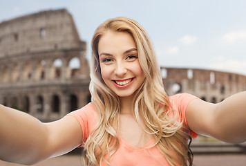 Image showing happy smiling young woman taking selfie