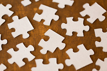 Image showing close up of puzzle pieces on wooden surface