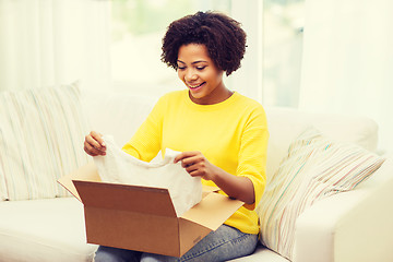 Image showing happy african young woman with parcel box at home