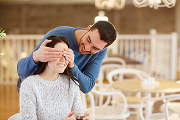 Image showing happy couple drinking tea at cafe