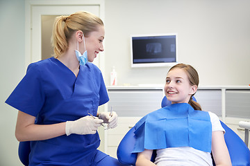 Image showing female dentist checking patient girl teeth