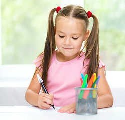 Image showing Cute cheerful child drawing using felt-tip pen