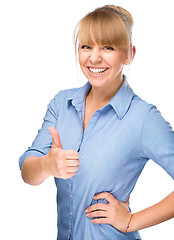 Image showing Woman is showing thumb up gesture