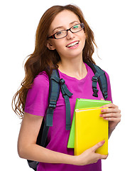 Image showing Young student girl is holding book