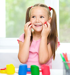 Image showing Girl is having fun while playing with plasticine