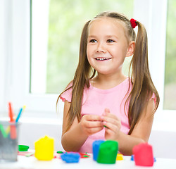 Image showing Girl is having fun while playing with plasticine