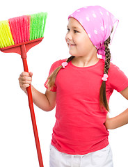 Image showing Young girl is dressed as a cleaning maid