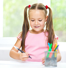 Image showing Cute cheerful child drawing using felt-tip pen