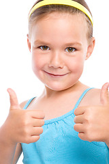 Image showing Little girl is showing thumb up gesture