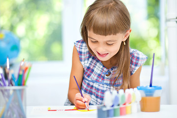 Image showing Little girl is painting with gouache