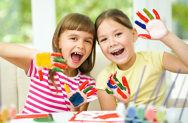 Image showing Little girls are painting with gouache