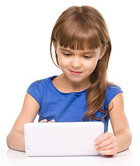 Image showing Young girl is using tablet