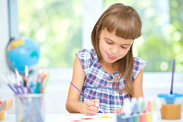 Image showing Little girl is painting with gouache