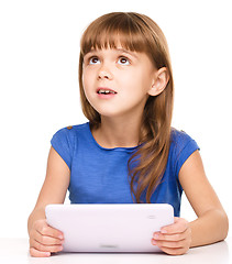 Image showing Young girl is using tablet